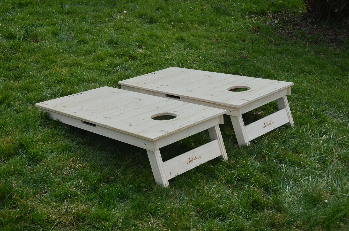 cornhole 2 planches bois naturel, sur le gazon, vue de derrière