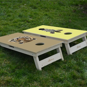cornhole 2 planches tête de tigre et tête de zèbre, sur le gazon, vue de derrière